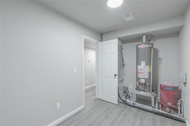 utility room featuring water heater