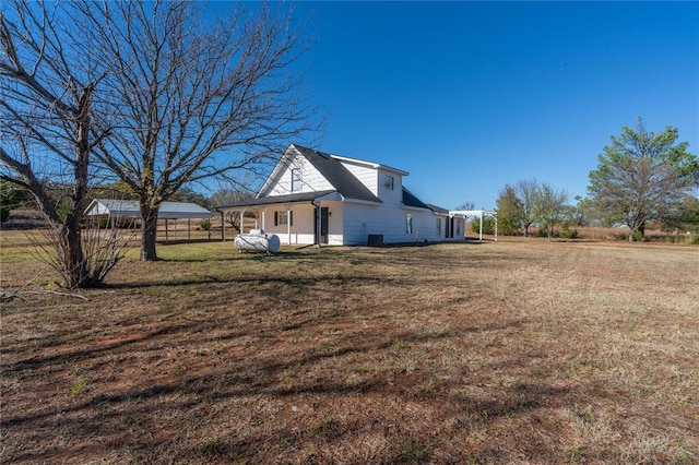 view of side of home with a yard