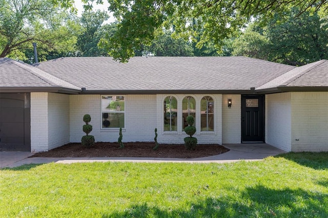 1112 Mary Lee Ln, Edmond, OK 73034 - single story home with brick siding, a shingled roof, a front lawn, and an attached garage