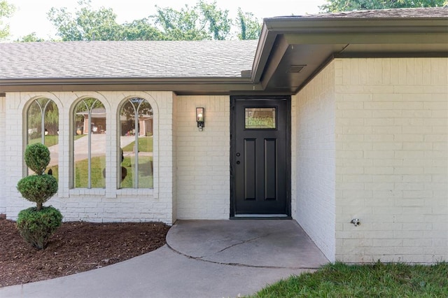 1112 Mary Lee Ln, Edmond, OK 73034 - doorway to property featuring a shingled roof and brick siding