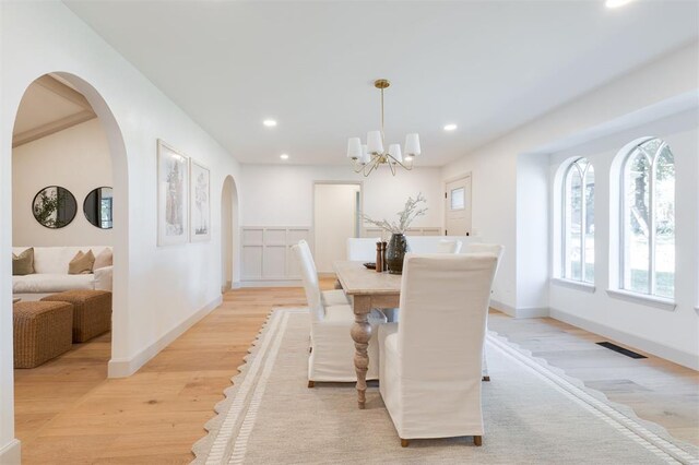 1112 Mary Lee Ln, Edmond, OK 73034 - dining room featuring light wood-style flooring, recessed lighting, a chandelier, and arched walkways