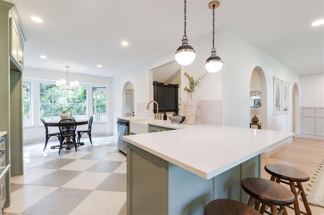 1112 Mary Lee Ln, Edmond, OK 73034 - kitchen with arched walkways, light countertops, a breakfast bar, a peninsula, and recessed lighting