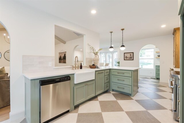 1112 Mary Lee Ln, Edmond, OK 73034 - kitchen featuring dishwasher, green cabinets, arched walkways, light flooring, and a peninsula