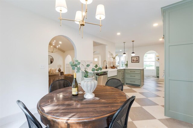 1112 Mary Lee Ln, Edmond, OK 73034 - dining room featuring arched walkways, light floors, a chandelier, and recessed lighting