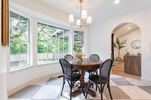 1112 Mary Lee Ln, Edmond, OK 73034 - dining area featuring arched walkways, a chandelier, light flooring, and recessed lighting