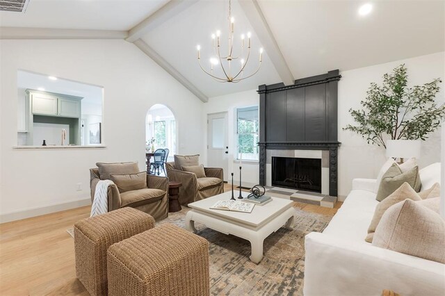 1112 Mary Lee Ln, Edmond, OK 73034 - living area with arched walkways, a chandelier, light wood-type flooring, a large fireplace, and recessed lighting