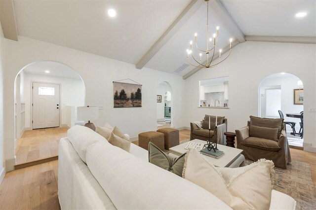 1112 Mary Lee Ln, Edmond, OK 73034 - living room with arched walkways, light wood-style flooring, a chandelier, and recessed lighting
