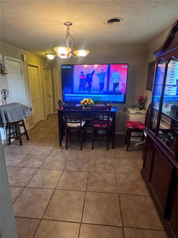 4306 NW Williams Ave, Lawton, OK 73505 - dining room with a textured ceiling and tile patterned floors