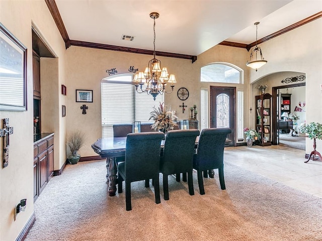 3705 Dalston Cir, Norman, OK 73072 - dining area featuring light carpet, a chandelier, ornamental molding, and arched walkways