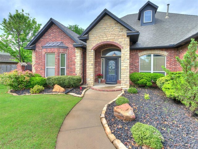 3705 Dalston Cir, Norman, OK 73072 - view of front of home with a shingled roof, brick siding, and stone siding