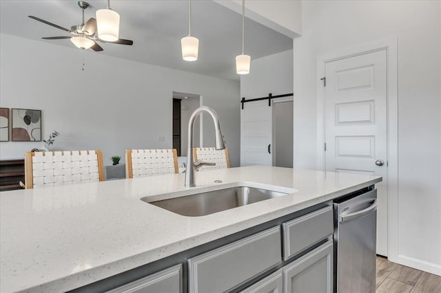 1108 Blackjack Creek Dr, Yukon, OK 73099 - kitchen featuring dishwasher, light stone countertops, a barn door, and decorative light fixtures