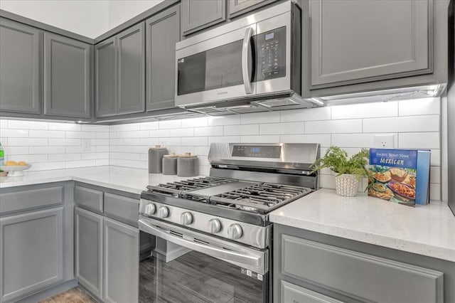 1108 Blackjack Creek Dr, Yukon, OK 73099 - kitchen featuring stainless steel appliances, gray cabinets, and decorative backsplash