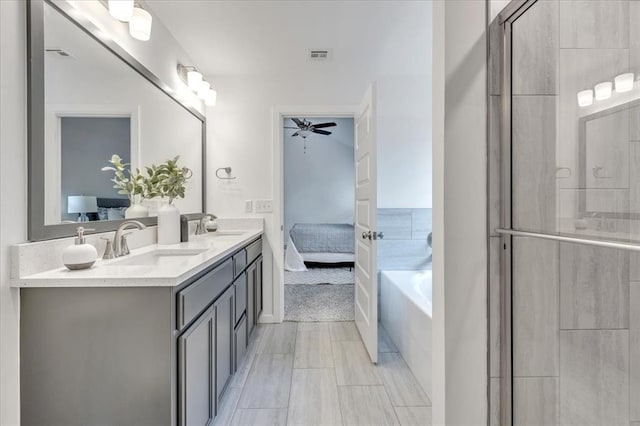 1108 Blackjack Creek Dr, Yukon, OK 73099 - full bath featuring ensuite bath, double vanity, a bath, a tile shower, and ceiling fan