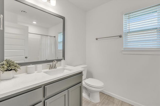1108 Blackjack Creek Dr, Yukon, OK 73099 - full bathroom with vanity, wood finished floors, and a shower with shower curtain