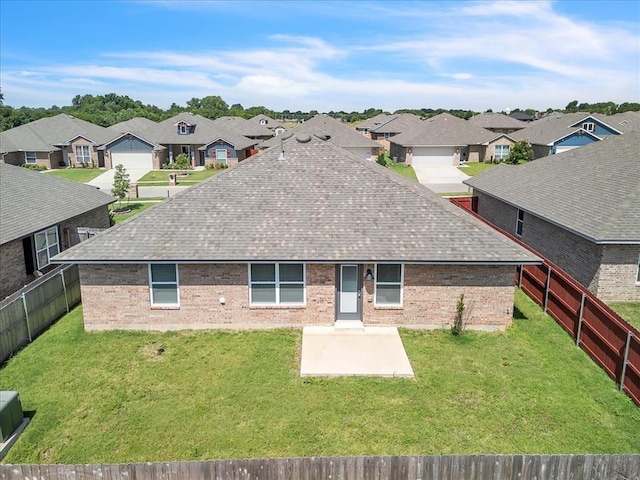1108 Blackjack Creek Dr, Yukon, OK 73099 - back of property featuring a shingled roof, brick siding, and a residential view
