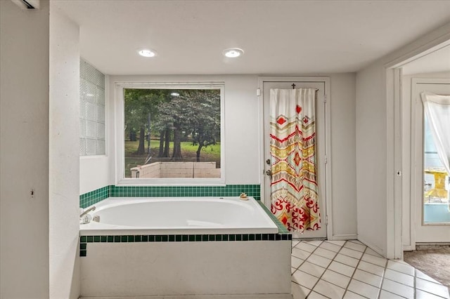 417 Garth Brooks Blvd, Yukon, OK 73099 - full bathroom featuring a garden tub, plenty of natural light, and tile patterned flooring