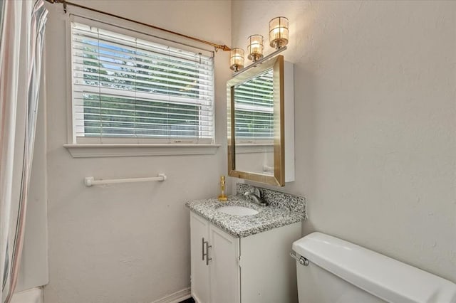 417 Garth Brooks Blvd, Yukon, OK 73099 - bathroom featuring healthy amount of natural light, vanity, and a textured wall
