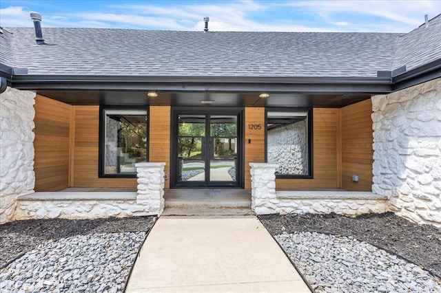 1205 Shalamar Rd, Edmond, OK 73013 - doorway to property featuring roof with shingles and stone siding