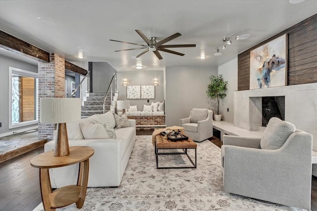 1205 Shalamar Rd, Edmond, OK 73013 - living room with ceiling fan, wood finished floors, stairs, and a premium fireplace