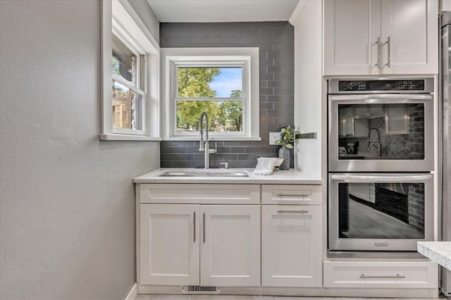 1205 Shalamar Rd, Edmond, OK 73013 - bar with stainless steel double oven and backsplash