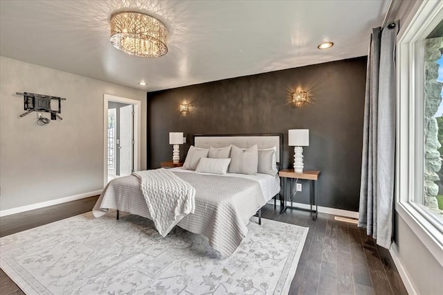 1205 Shalamar Rd, Edmond, OK 73013 - bedroom with an accent wall, a chandelier, dark wood-style flooring, and recessed lighting