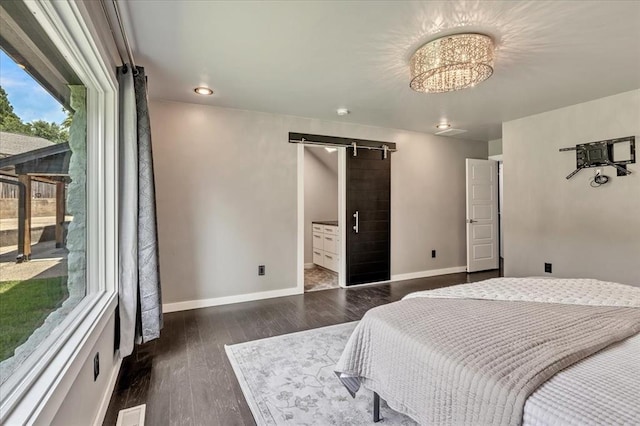 1205 Shalamar Rd, Edmond, OK 73013 - bedroom featuring a barn door, dark wood-style flooring, and a chandelier