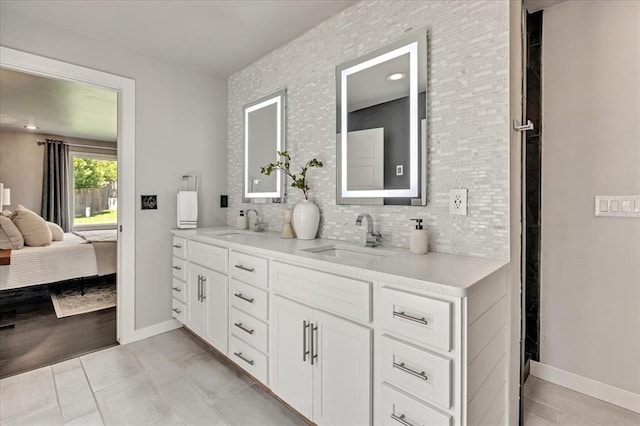 1205 Shalamar Rd, Edmond, OK 73013 - ensuite bathroom featuring double vanity and tasteful backsplash
