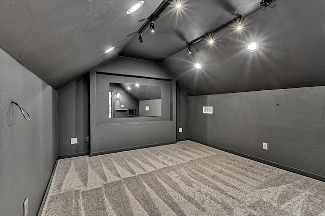 1205 Shalamar Rd, Edmond, OK 73013 - home theater room featuring carpet flooring, lofted ceiling, and track lighting