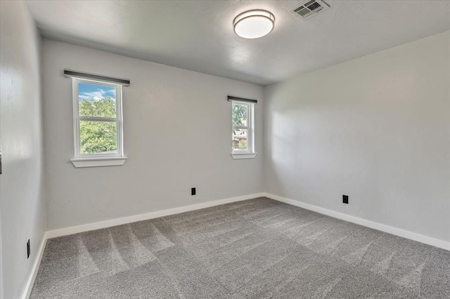 1205 Shalamar Rd, Edmond, OK 73013 - spare room with plenty of natural light and carpet