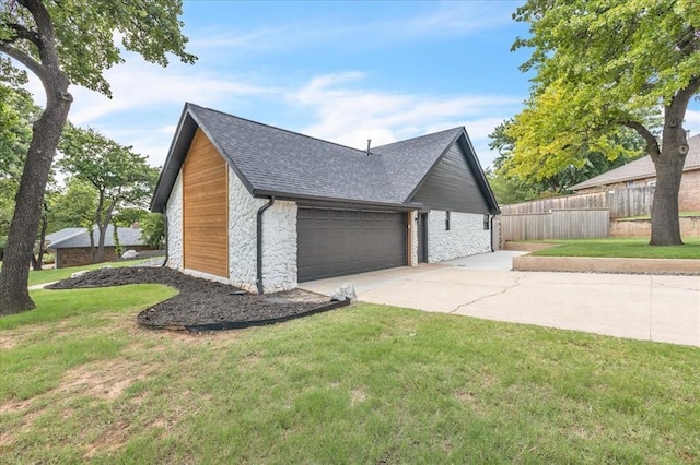 1205 Shalamar Rd, Edmond, OK 73013 - view of property exterior featuring roof with shingles, concrete driveway, an attached garage, and stone siding