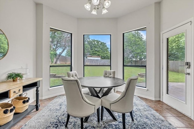 732 Tuscany Way, Edmond, OK 73034 - tiled dining area with a chandelier and baseboards
