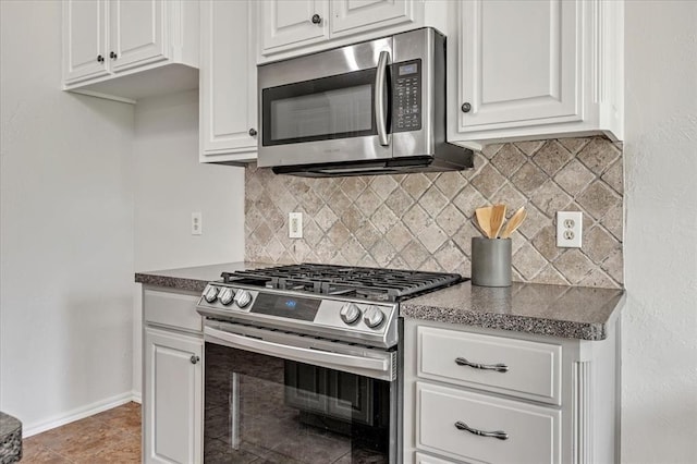732 Tuscany Way, Edmond, OK 73034 - kitchen featuring appliances with stainless steel finishes, tasteful backsplash, white cabinetry, and dark countertops