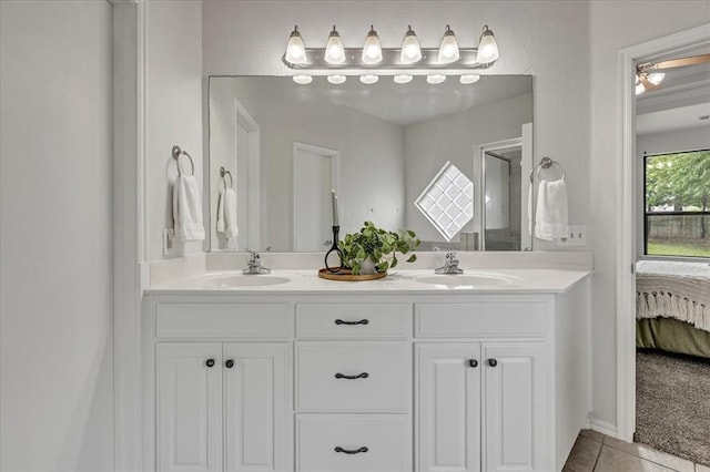 732 Tuscany Way, Edmond, OK 73034 - ensuite bathroom with double vanity, tile patterned flooring, and a shower stall