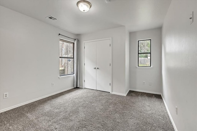 732 Tuscany Way, Edmond, OK 73034 - unfurnished bedroom with carpet and a closet