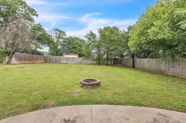 732 Tuscany Way, Edmond, OK 73034 - fenced backyard with a fire pit