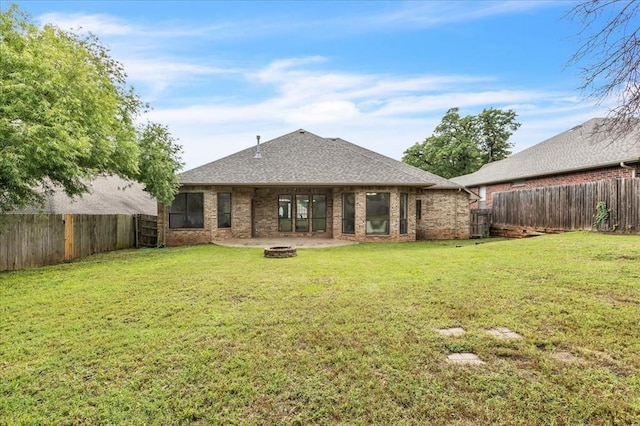 732 Tuscany Way, Edmond, OK 73034 - back of house featuring an outdoor fire pit, a fenced backyard, and brick siding