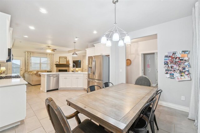 609 NW 180th St, Edmond, OK 73012 - dining area featuring light tile patterned flooring, ceiling fan, recessed lighting, and a chandelier