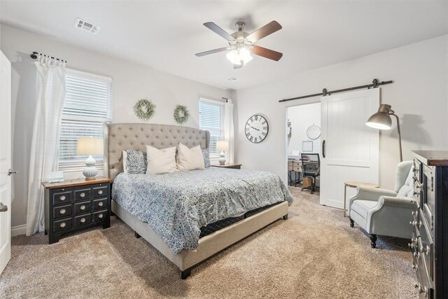609 NW 180th St, Edmond, OK 73012 - bedroom with a barn door, carpet flooring, and ceiling fan