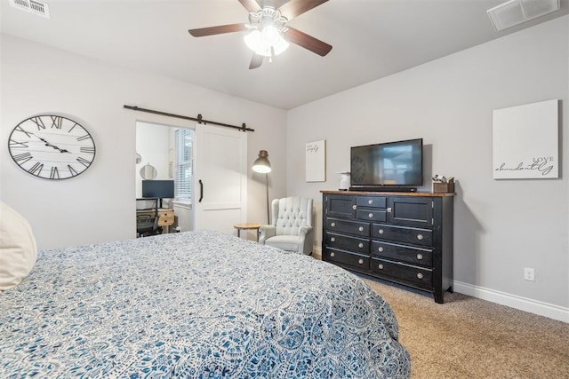 609 NW 180th St, Edmond, OK 73012 - bedroom with a barn door, carpet flooring, and ceiling fan