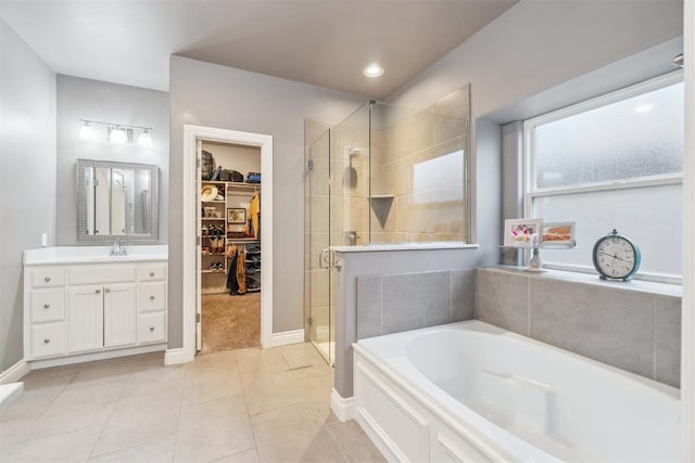 609 NW 180th St, Edmond, OK 73012 - full bathroom with a spacious closet, a stall shower, a garden tub, and vanity