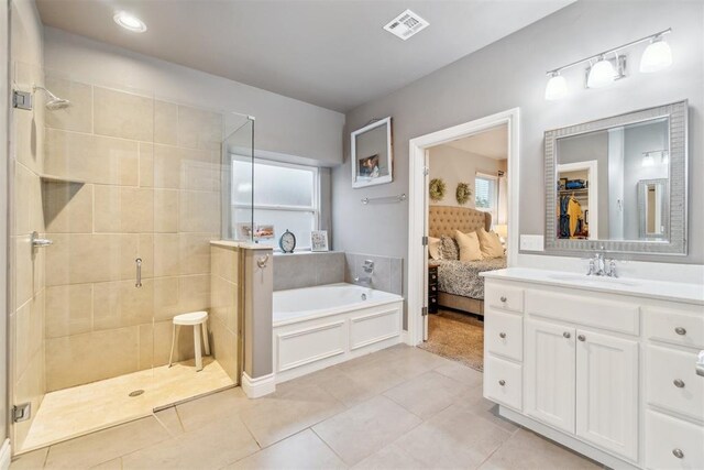 609 NW 180th St, Edmond, OK 73012 - ensuite bathroom with a garden tub, a shower stall, tile patterned floors, and vanity