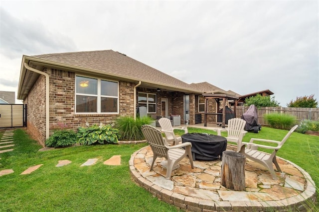 609 NW 180th St, Edmond, OK 73012 - rear view of house with a fire pit, a fenced backyard, brick siding, a patio area, and roof with shingles
