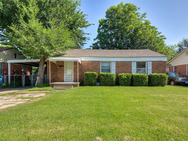 109 E Northrup Dr, Oklahoma City, OK 73110 - ranch-style house with brick siding, driveway, and an attached carport