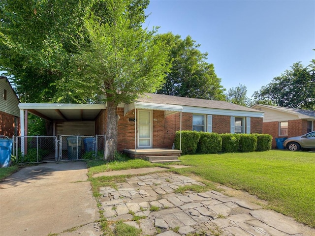 109 E Northrup Dr, Oklahoma City, OK 73110 - view of front of home with a gate, driveway, brick siding, and a carport