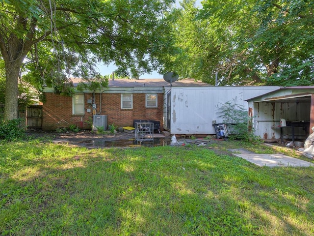 109 E Northrup Dr, Oklahoma City, OK 73110 - back of house with a yard and brick siding