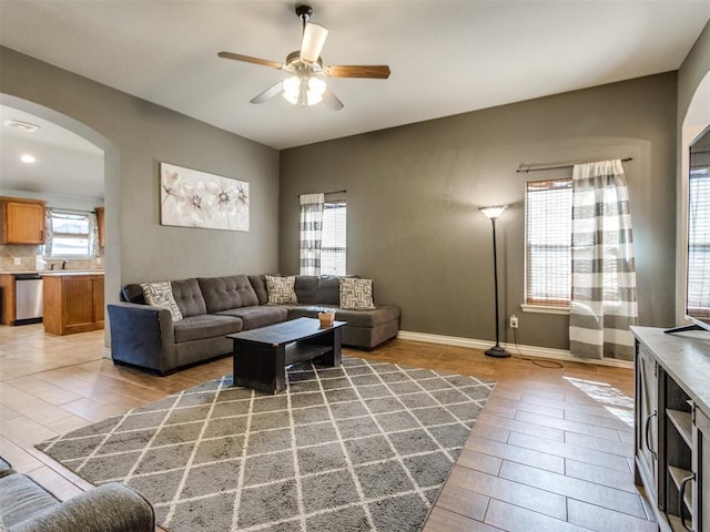 13312 4th Ter, Yukon, OK 73099 - living area with arched walkways, a ceiling fan, and light wood-style floors