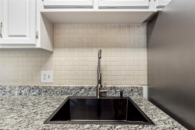 14405 N Pennsylvania Ave Unit 6D, Oklahoma City, OK 73134 - kitchen view of tasteful backsplash, white cabinetry, and light stone countertops