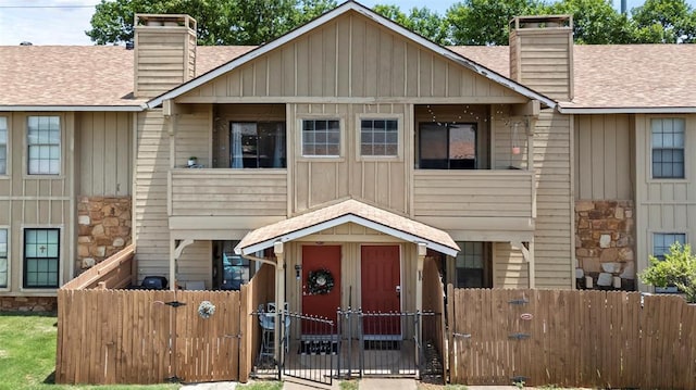 14405 N Pennsylvania Ave Unit 6D, Oklahoma City, OK 73134 - view of front of home featuring a chimney, a gate, board and batten siding, and a shingled roof