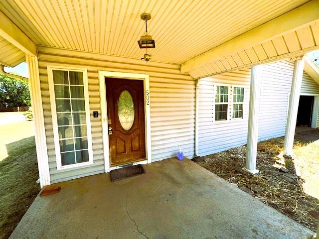 502 E Cavalry St, Cordell, OK 73632 - view of exterior entry featuring covered porch