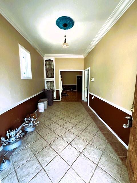 502 E Cavalry St, Cordell, OK 73632 - unfurnished dining area with crown molding and light tile patterned floors